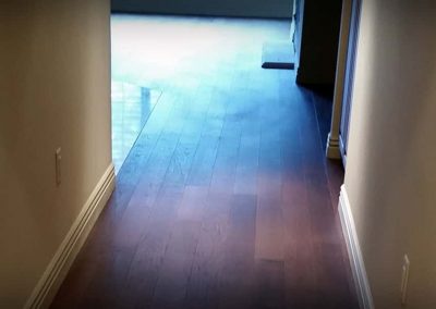 Hardwood floor installation on hallway and livingroom area.